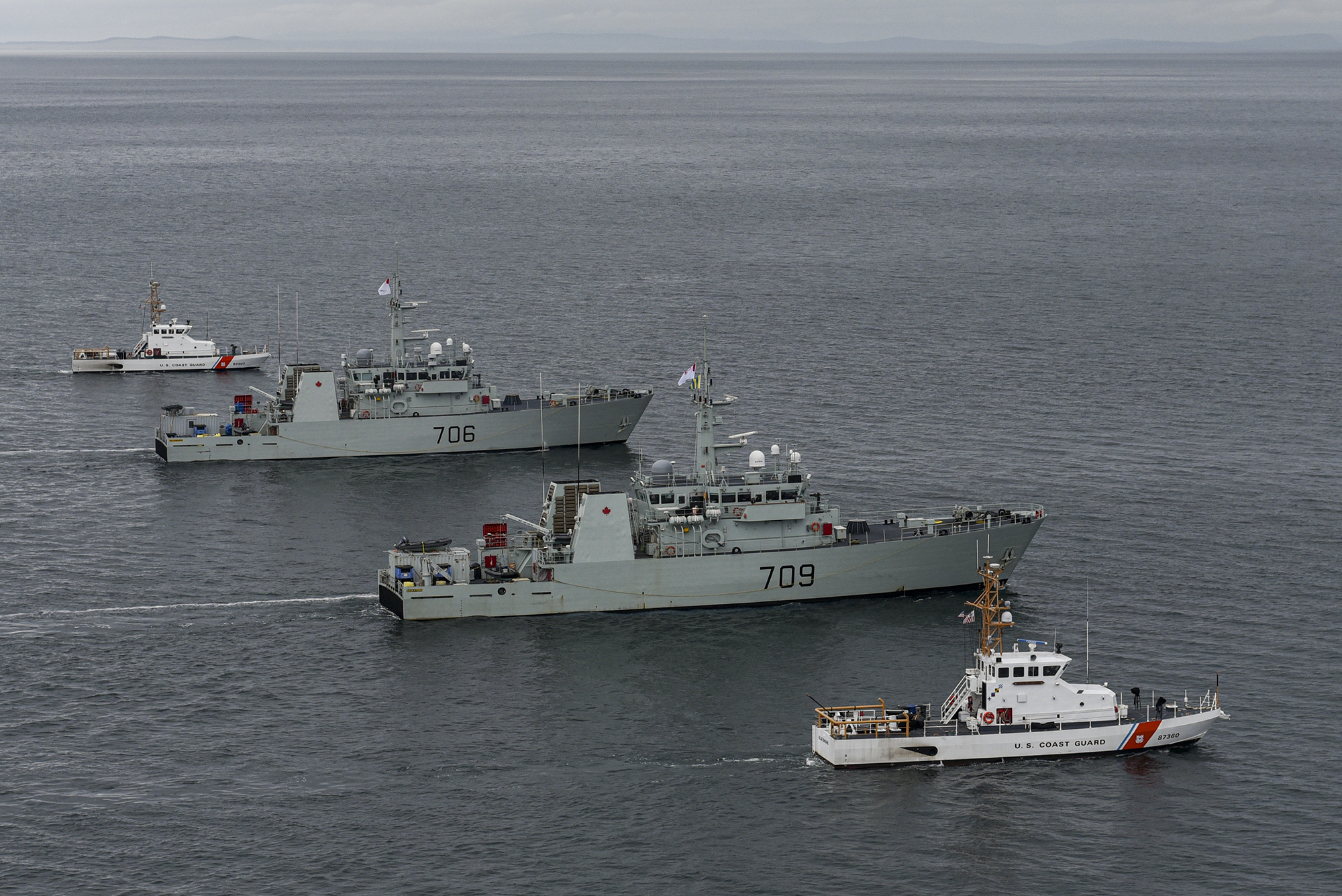 U.S. Coast Guard Cutter Blue Shark [WPB 87360] and U.S. Coast Guard Cutter Osprey [WPB 87307] flank HMCS Saskatoon and HMCS Yellowknife from the Royal Canadian Navy during a joint exercise in the Salish Sea on Feb. 17, 2022. The exercise was conducted to train and prepare Royal Canadian Navy crews for deployments to support United States counter-narcotics operations. Photo: U.S. Coast Guard
