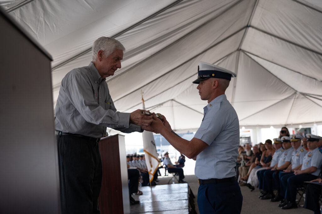 The long glass is presented to Mr. Michael Scheuerman during the Coast Guard Cutter John Scheuerman's commissioning ceremony in Tampa, Florida, Feb. 23, 2022. The John Scheuerman is the 46th Sentinel-class fast response cutter and the fifth of six FRC's to be homeported in Manama, Bahrain, which will replace the aging 110’ Island Class Patrol Boats. Photo: United States Coast Guard