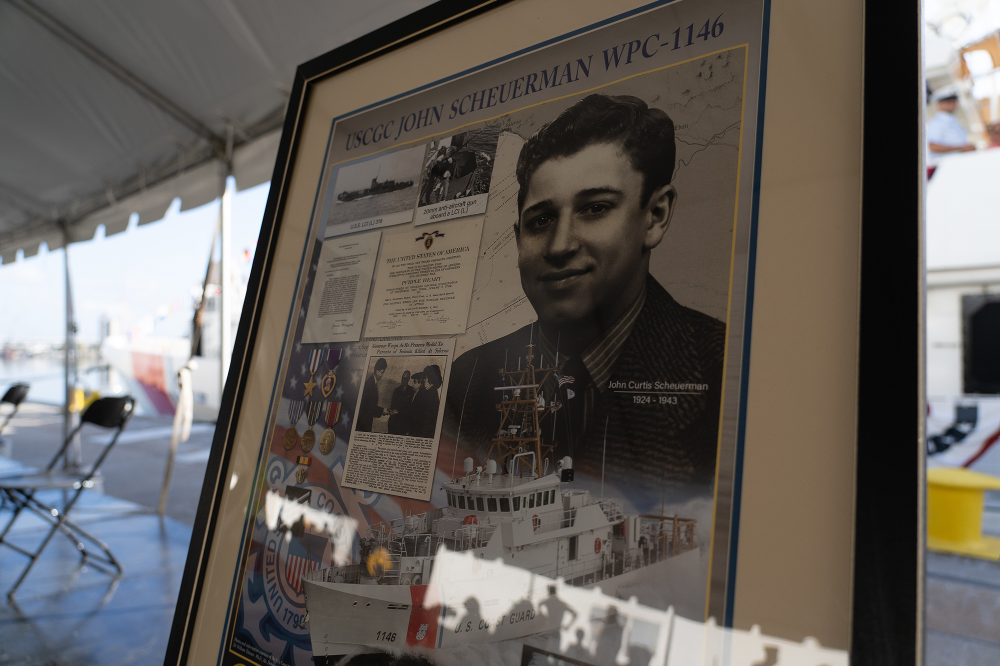The Coast Guard Cutter John Scheuerman's poster is displayed during the vessel's commissioning ceremony in Tampa, Florida, Feb. 23, 2022. The John Scheuerman is the 46th Sentinel-class fast response cutter and the fifth of six FRC's to be homeported in Manama, Bahrain, which will replace the aging 110’ Island Class Patrol Boats. Photo: U.S. Coast Guard