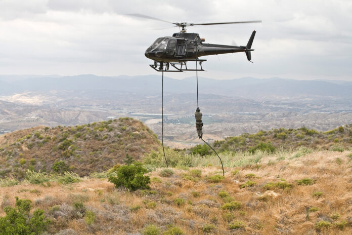 Eurocopter AS350 Ecureuil A-Star Helicopter flying over the hills of Malibu, CA during a Fast Rope type military operation. Photo: Airbus