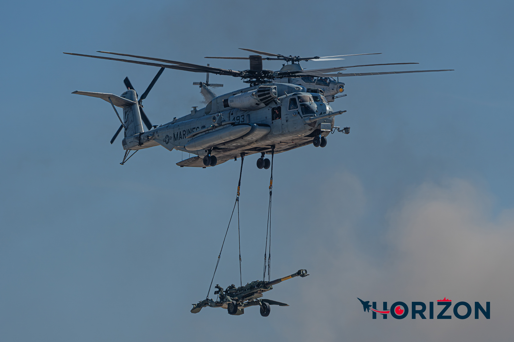 US Marine Corps CH-53E Super Stallion from Marine Heavy Helicopter Squadron 465 "Warhorse" (HMH-465) carrying an M777 Howitzer artillery cannon.