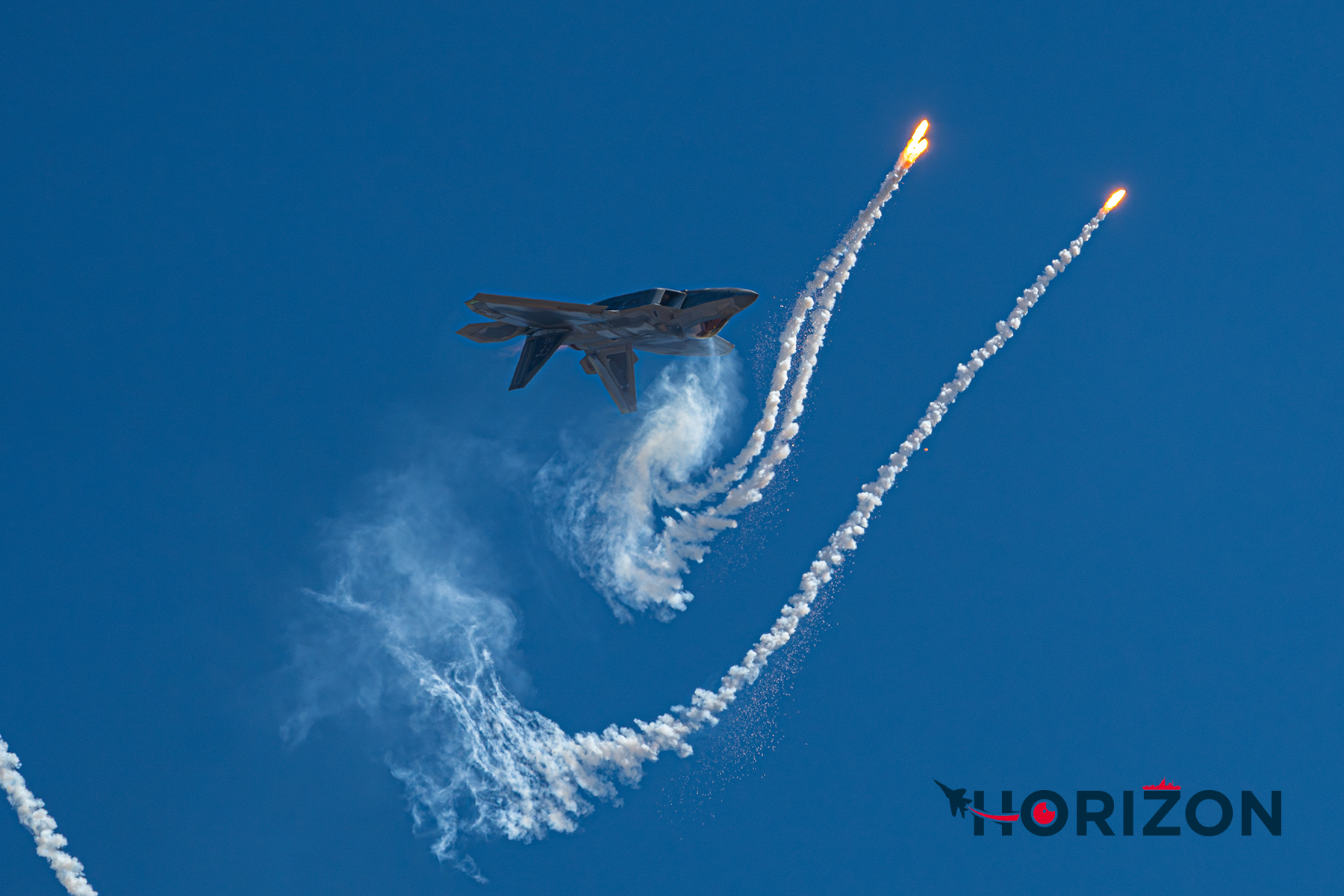 United States Air Force F-22 releasing countermeasure flares