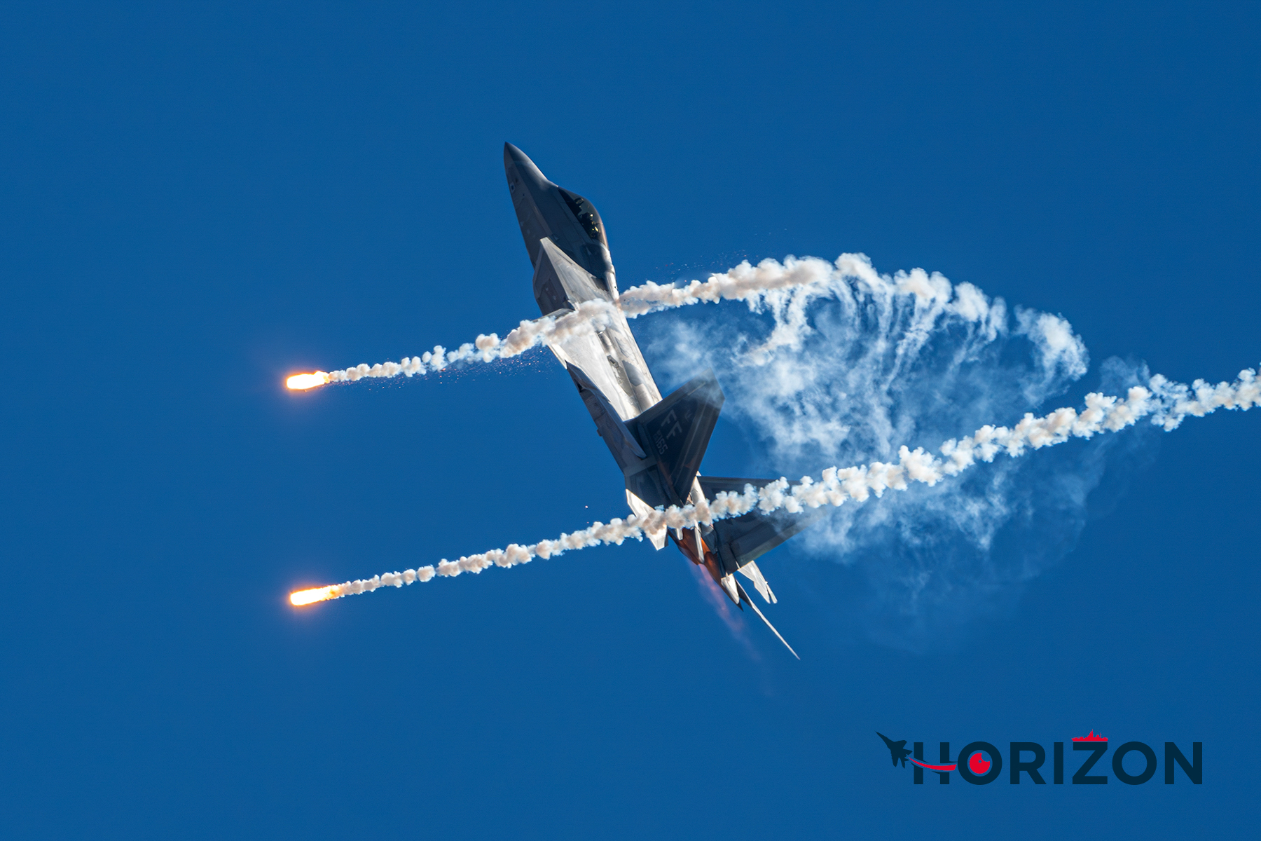 United States Air Force F-22 releasing countermeasure flares