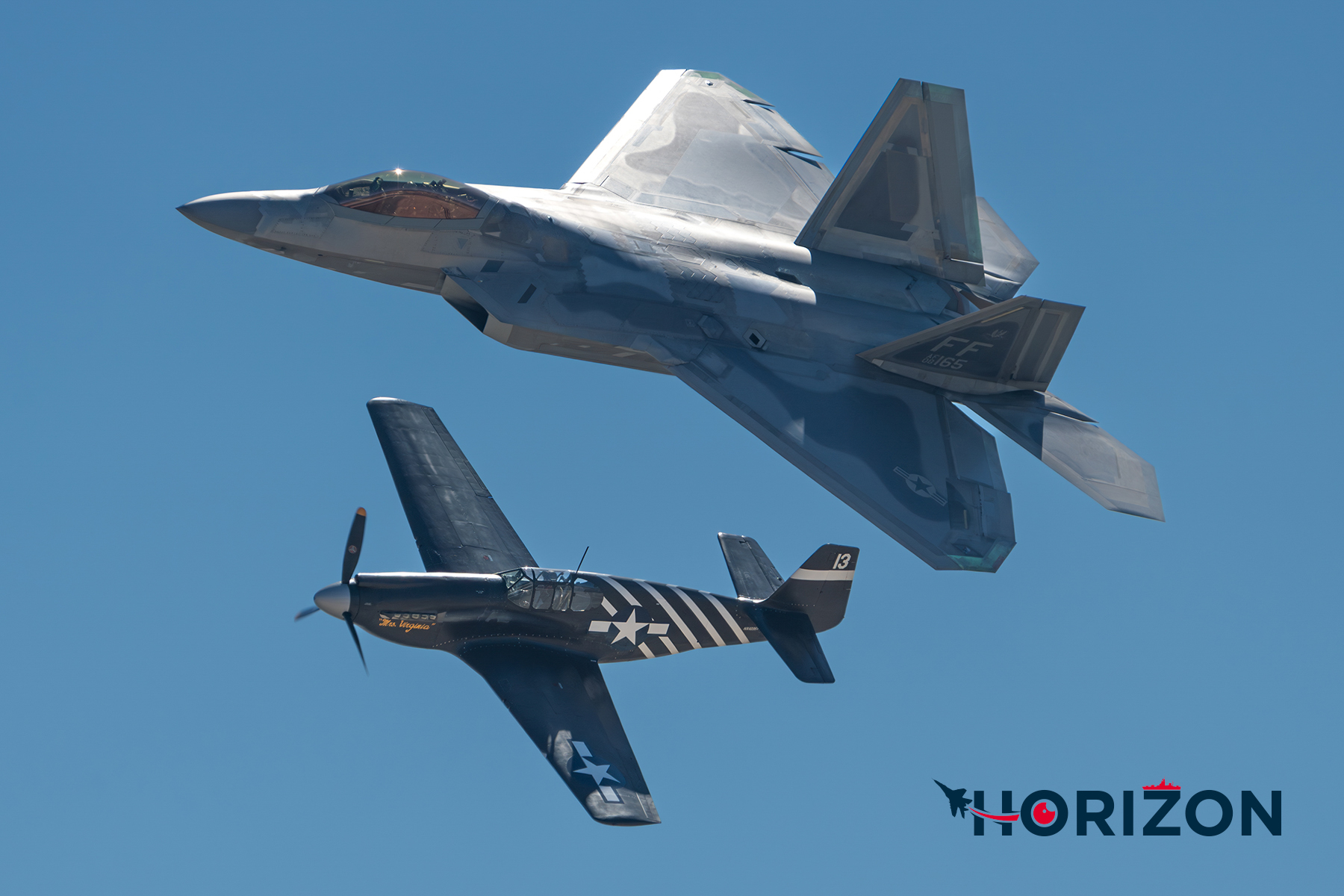 United States Air Force F-22 following alongside a Planes of Fame Museum P-51 during the Heritage Flight